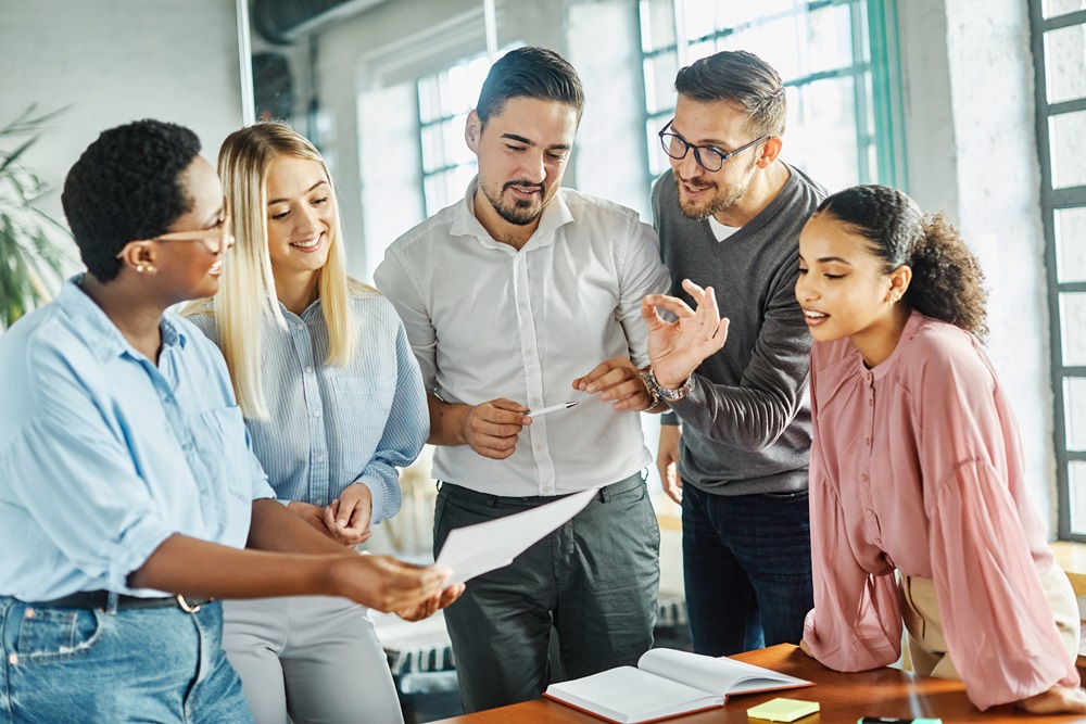 Diverse team coming together to strategize over SME travel management