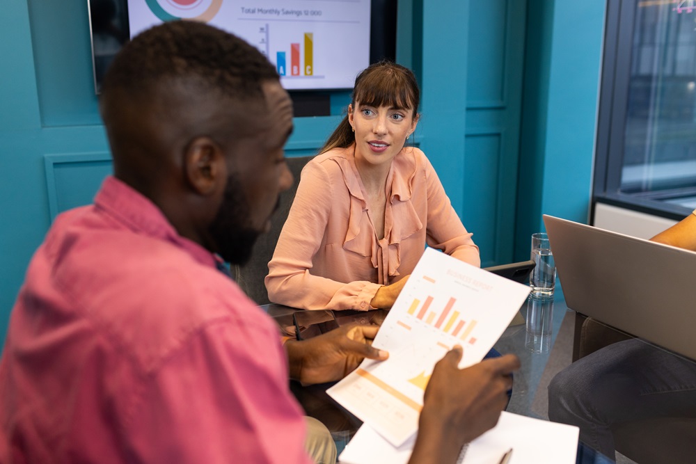 Colleagues looking at travel management reports and insights
