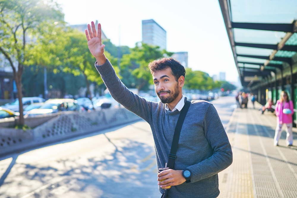 Man on business trip hailing a taxi