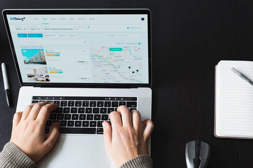 Laptop with GetGoing search results for hotels in Valencia.