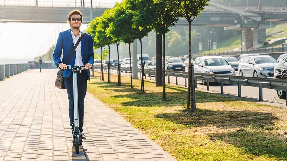 business traveler in the city on scooter