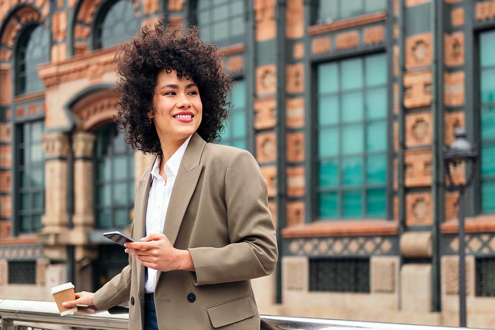 successful business woman smiling with a phone guide to business travel