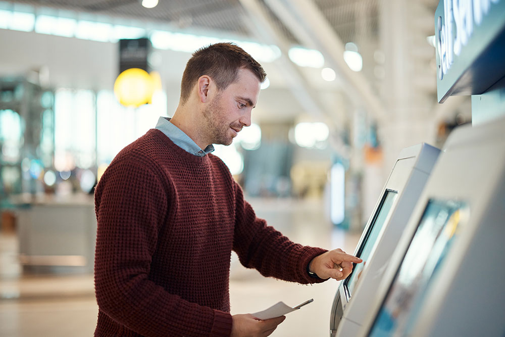 man-airport-and-self-service-for-check-in-ticket-2023-03-09-09-05-37-utc_1000x667