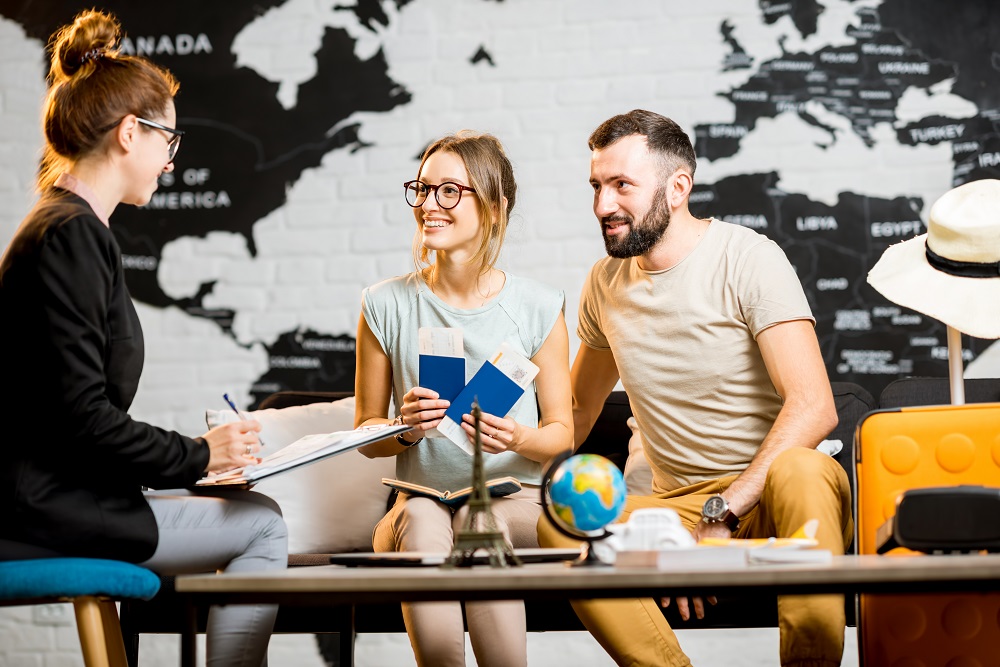 Couple meeting with travel agent with map in the background