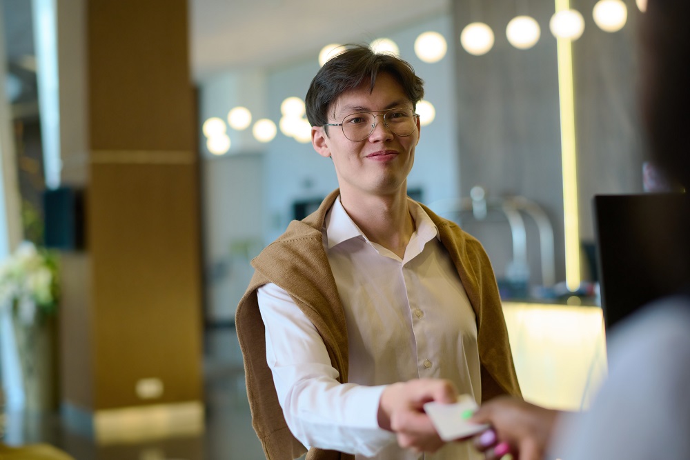 Asian business traveler checking in to hotel