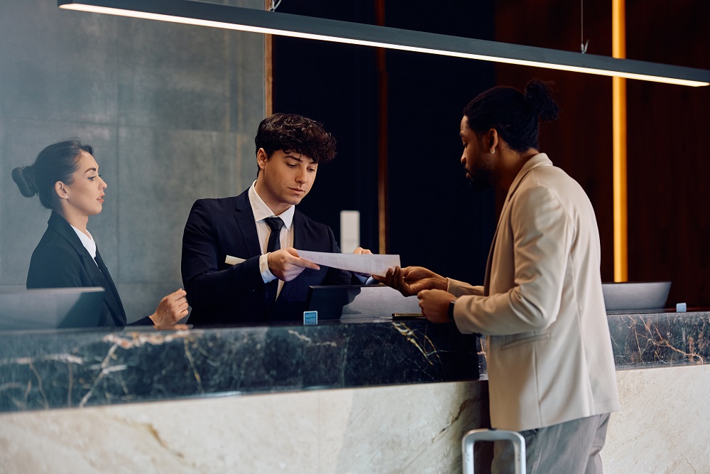 Man checking in to hotel for business