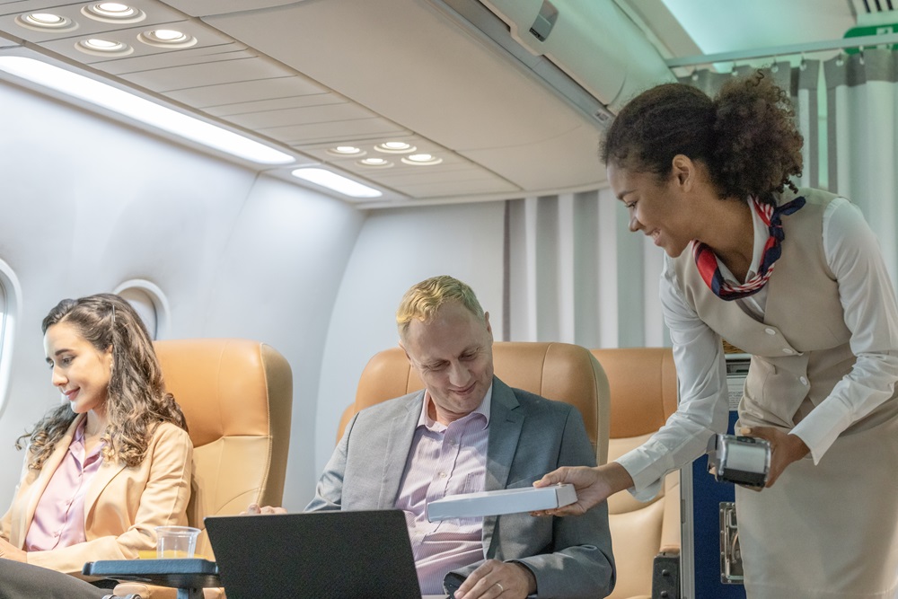 Business travelers on business class purchasing from a stewardess