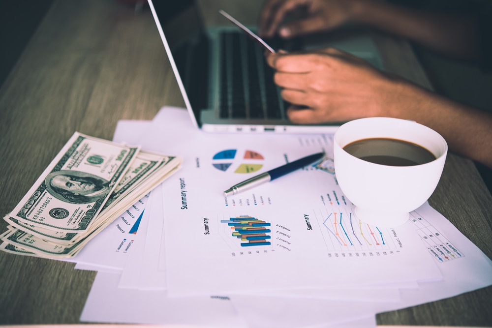 Finance team analyzing business travel expenses with a cup of coffee