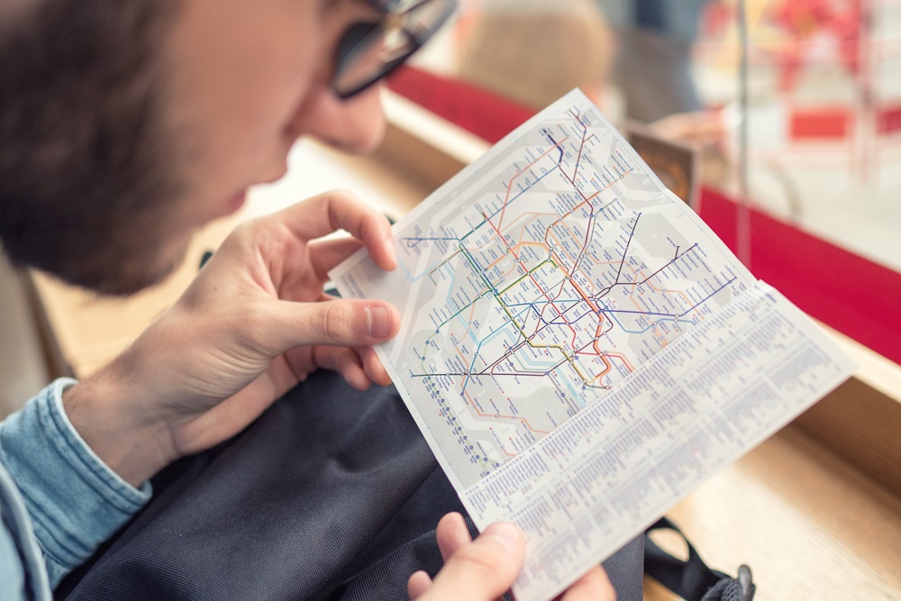 Man looking at London underground map