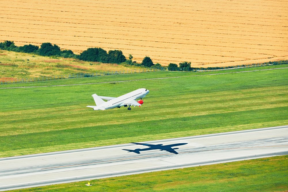 Plane taking off in a field on the runway